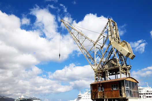 Old Vintage Wooden Port Crane on a Blue Sky