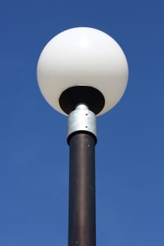 a street lamp with a large, spherical glass body