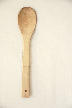 Wooden spoon on fabric in vintage style