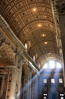 Interior of Saint Peters Basilica with crepuscular rays, Vatican City, Rome