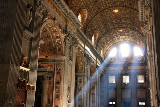 Interior of Saint Peters Basilica with crepuscular rays, Vatican City, Rome