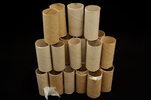 Empty Toilet Rolls Stack Up On a Black Background