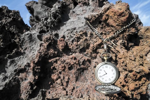 Time Concept Classic Vintage Pocket Clock on the Volcanic Rocks