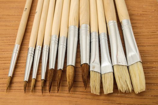 New Wooden Different Paintbrush Set Texture over a Colored Background