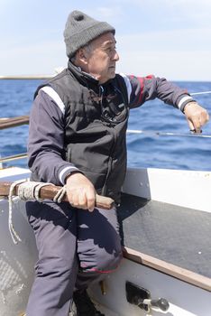 The educational journey of Skipper and child in the midst of the sea, with a sailing boat in Sardinia.