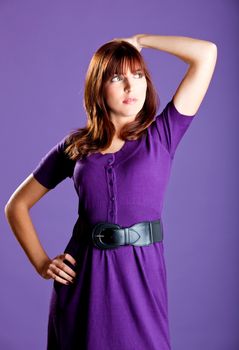 Portrait of a beautiful fashion woman over a violet background