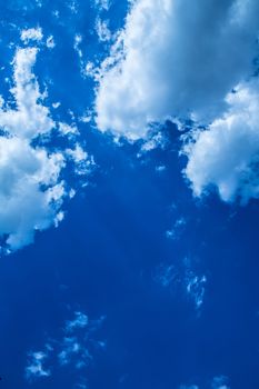 A blue sky with some fluffy clouds.