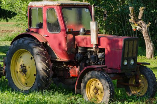 cloes up of rural red old farm tractor outdoor