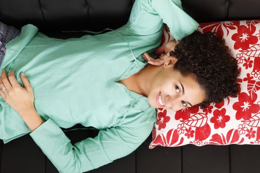 A jung brazilian woman relaxing on the sofa.