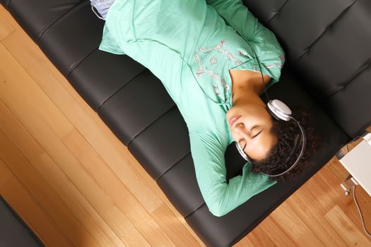 A jung brazilian woman relaxing on the sofa.