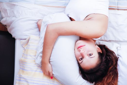 A young woman relaxing on the bed.