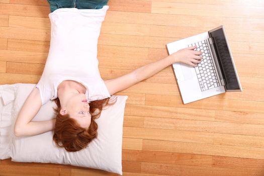 A young woman surfing on the Internet with a Laptop.  
