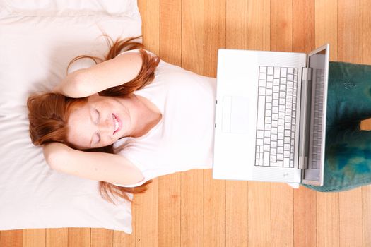 A young woman surfing on the Internet with a Laptop. 
