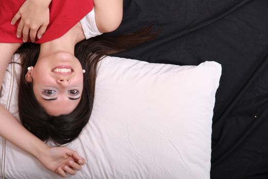 A young hispanic Woman sleeping on the Bed.
