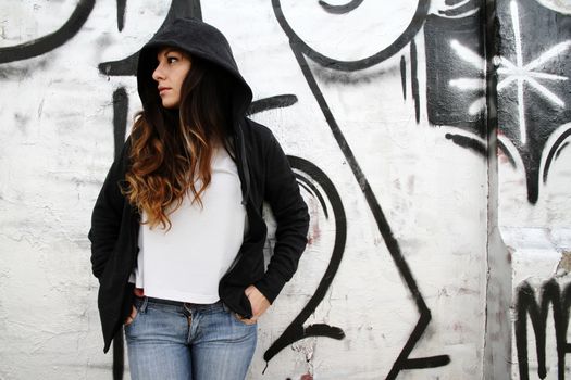 A young woman leaning on a wall.