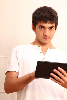 A young, latin man with a Tablet PC, face in focus
