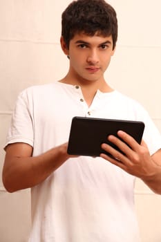 A young, latin man with a Tablet PC, face in focus
