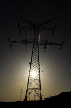 Electric Power Line Pylon over a colored Sunset