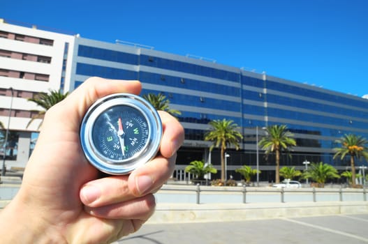 Orientation Concept a Male Hand Holding Metal Compass in a City