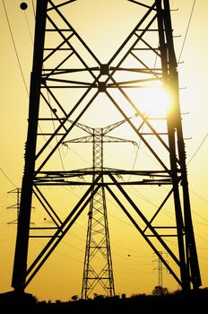 Electric Power Line Pylon over a colored Sunset