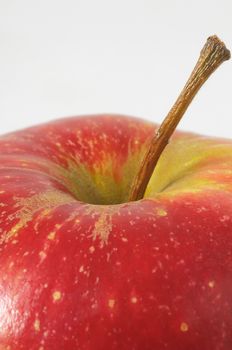 One Juicy Hot Red Apple over a White Background
