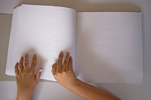 fingers and braille. blind people read a book in braille.