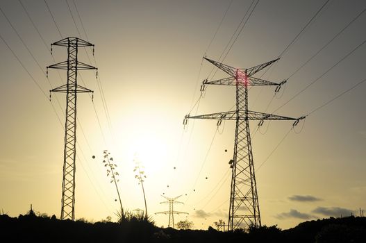 Electric Power Line Pylon over a colored Sunset