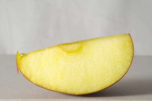 One Slice of Red Apple on a Colored Background