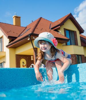 Cute little girl plaing in the pool