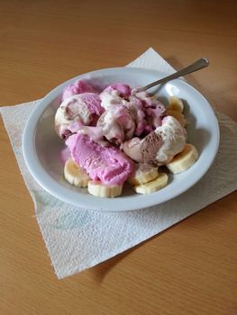 Banana split with vanilla, chocolate and strawberry ice cream