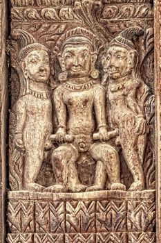 Detail of erotic wood carvings  set into the brickwork of temple in Durbar Square, Bhaktapur town, Nepal