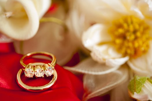  wedding rings on  a colorful fabric background