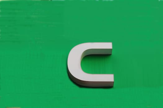 On the smooth green background shows volumetric letter ?