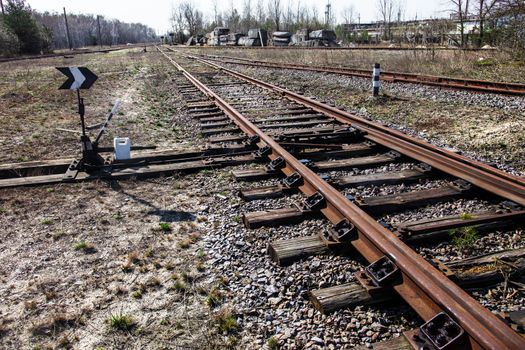 Old railroad tracks and railroad switch with point indicator