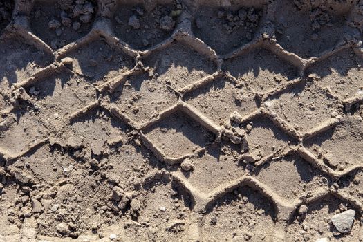 Closeup of the wheel tracks on the ground.