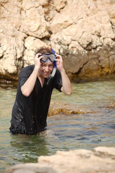 Young man snorkeling happily in the sea