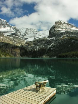 Chair on a wooden pier, Lake O'Hara, Yoho National Park, British Columbia, Canada