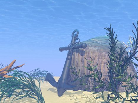 Underwater anchor on sand against rock next to plants