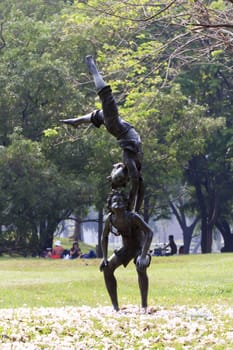 Statue of acrobatics at park in bangkok, thailand