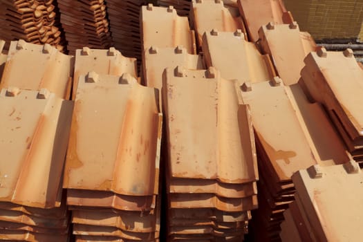 Close up of a stack of ceramic roof tiles.