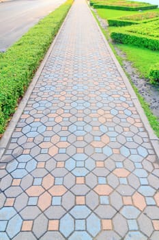 Sidewalk made of bricks in various colors.