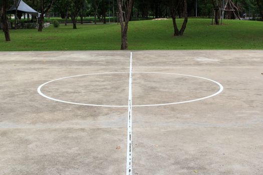 Basketball playground made of concrete and painted line of white.