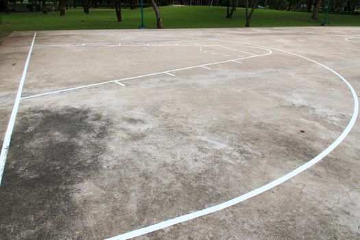 Basketball playground made of concrete and painted line of white.