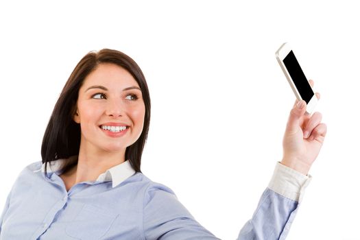 Portrait of young smiling brunette woman taking a self portrait with her phone