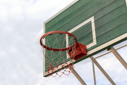 Outdoor Basketball Hoop against a cloudy sky.