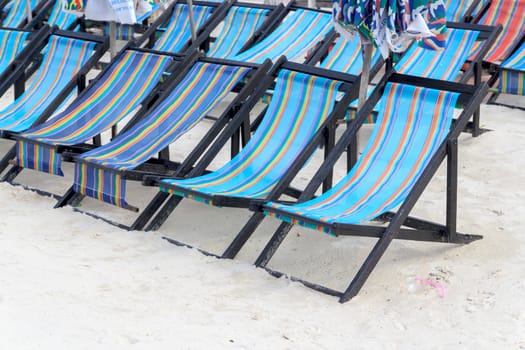 Beach chair a lot on the beach.