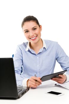 Portrait of young smiling businesswoman using tablet on her desk 