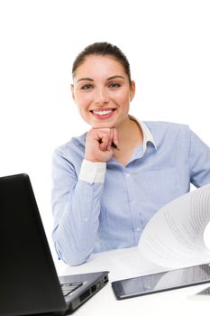 Portrait of young smiling businesswoman on her desk