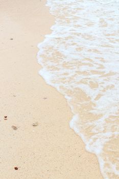 Soft wave of the sea on the sandy beach 