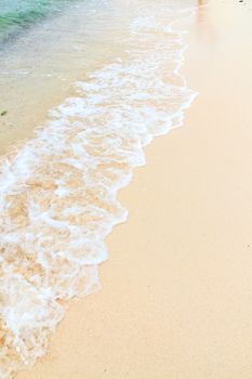 Soft wave of the sea on the sandy beach.